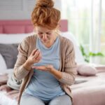 Woman having flu taking medicine after doctor prescription